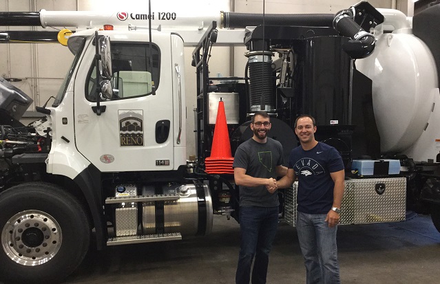 NDEP and City of Reno staff shake hands in front of a brand new sewer/vacuum truck